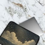 Infidu Night Sky Clouds Stars Laptop Sleeve with dark background, stars, and clouds design. The laptop sleeve covers the laptop