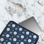 Infidu Dark Blue Winter Snowflake & Gift Laptop Sleeve with festive snowflakes, gifts, and a holiday design. The laptop sleeve covers the laptop