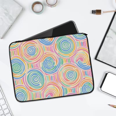 Laptop sleeve with a playful pastel spiral design on a white background. laptop sleeve kept on a plain white background