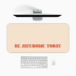 Infidu desk pad with 'Be Awesome Today' in orange text on a beige background, providing a motivational and stylish desk mat. A desk pad under the computer