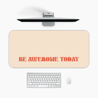 Infidu desk pad with 'Be Awesome Today' in orange text on a beige background, providing a motivational and stylish desk mat. A desk pad under the computer