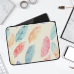 Infidu Pastel Feather Laptop Sleeve with soft fabric in pink, blue, and orange shades, featuring a zip closure for secure laptop protection. laptop sleeve kept on a plain white background