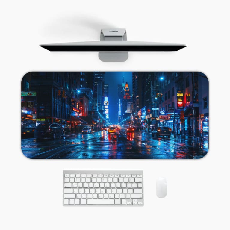 Infidu Neon Lights Midnight City Reflections Desk Pad shows a moody, rainy city scene with neon reflections, perfect for a modern workspace. A desk pad under the computer