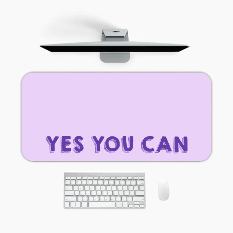 Infidu Yes You Can Desk Pad featuring motivational purple text on a minimalist purple background, perfect for inspiring confidence at your desk. A desk pad under the computer