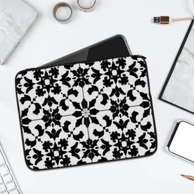 Infidu Black & White Laptop Sleeve with intricate symmetrical floral and geometric patterns, bold and stylish protective laptop case. laptop sleeve kept on a plain white background