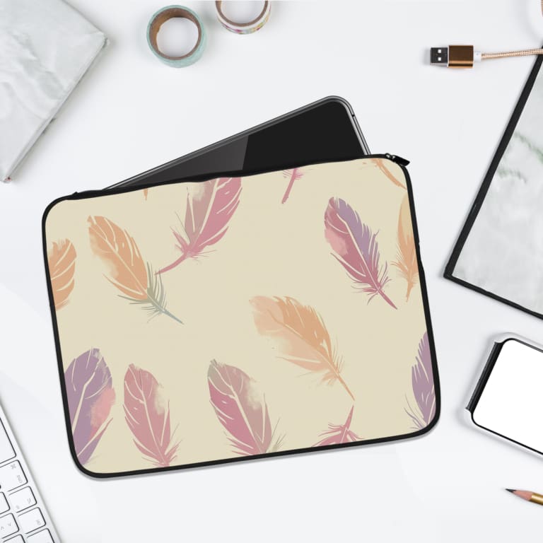 Infidu Pastel Feather Laptop Sleeve with a soft feather design in pastel shades on a light background, displayed on a white desk. laptop sleeve kept on a plain white background