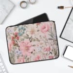 Laptop sleeve with a pastel floral design in pink, blue, and green on a white background, creating an elegant, gentle look. laptop sleeve kept on a plain white background