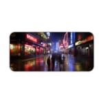 Infidu Neon City Street Design Desk Pad featuring a vibrant cityscape at night with neon signs, reflections on wet streets, and silhouettes of people walking. Desk Pad kept on a plain white background