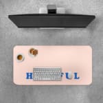 Infidu Hopeful Desk Pad with blue text on a baby pink background, motivational design Desk Pad with Keyboard and Mouse on top of the desk pad