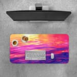 Infidu Calming Sunset Reflection Design Desk Pad featuring a sunset over water in soft shades of pink, purple, orange, and yellow. Desk Pad with Keyboard and Mouse on top of the desk pad