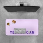 Infidu Yes You Can Desk Pad featuring motivational purple text on a minimalist purple background, perfect for inspiring confidence at your desk. A desk pad under the computer