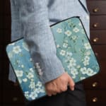 Blue floral laptop sleeve with white flower pattern, The laptop sleeve covers the laptop