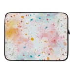 Colorful splatter paint design laptop sleeve with blue, orange, and pink splashes on a light background. laptop sleeve kept on a plain white background