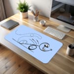 Infidu desk pad with cartoon character and playful swirl design on light blue background. desk pad kept on the table