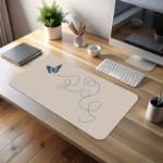 Infidu Blue Butterfly Desk Pad featuring a blue butterfly with a dotted flight path on a light background. desk pad kept on the table