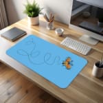 Infidu Yellow Butterfly Desk Pad featuring a yellow butterfly with a dotted flight path on a light background. desk pad kept on the table