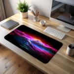 Infidu Neon Ocean Waves Design Desk Pad with vibrant shades of pink, purple, blue, and orange depicting ocean waves and sunset desk pad kept on the table