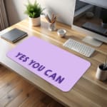 Infidu Yes You Can Desk Pad featuring motivational purple text on a minimalist purple background, perfect for inspiring confidence at your desk. desk pad kept on the table