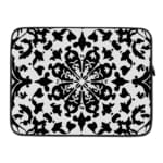 Laptop sleeve with a bold black and white floral or geometric design. laptop sleeve kept on a plain white background