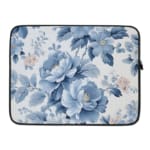 Laptop sleeve with a blue floral design, featuring light and dark blue flowers on a white background with a secure zip closure. laptop sleeve kept on a plain white background