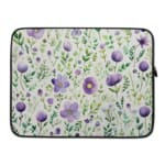 Laptop sleeve with purple floral design, featuring purple flowers and green leaves on a light background, with a secure zip closure. laptop sleeve kept on a plain white background