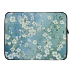 Blue floral laptop sleeve with white flower pattern,