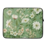 Floral laptop sleeve with white flowers and green leaves on a soft green background. laptop sleeve kept on a plain white background