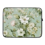 Floral laptop sleeve with white flowers and green leaves on a soft green background. laptop sleeve kept on a plain white background