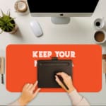 Infidu Keep Your Mind In A Happy Place Desk Pad with Motivational Orange Design A writing pad on top of the desk pad