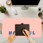 Infidu Hopeful Desk Pad with blue text on a baby pink background, motivational design A writing pad on top of the desk pad