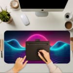 Infidu Wave Design Desk Pad features a neon landscape with a glowing purple and pink sun, wave patterns, and an 80s vaporwave aesthetic. A writing pad on top of the desk pad