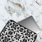 Infidu Black & White Laptop Sleeve with intricate symmetrical floral and geometric patterns, bold and stylish protective laptop case. The laptop sleeve covers the laptop